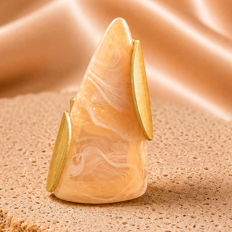 Decorative stone ring on a textured brown surface with a soft focus background