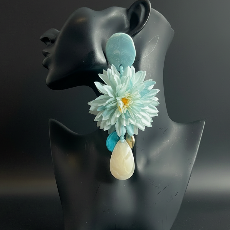 Floral earring on a black mannequin bust against a dark background