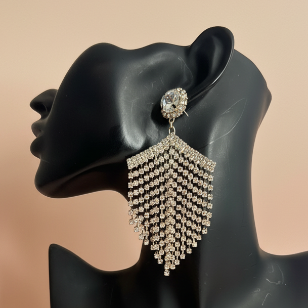 gold fringe rhinestone Earring displayed on a black mannequin ear with a beige background